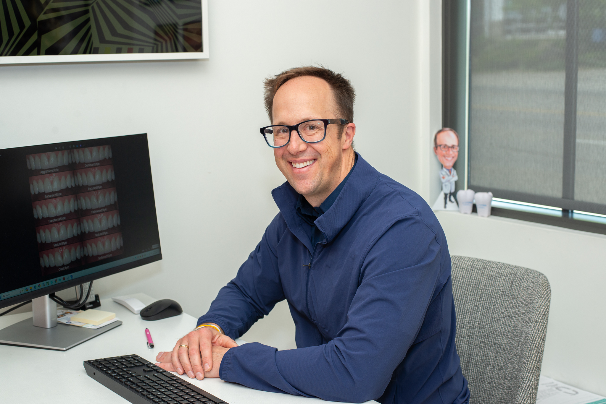 Dr. Burghart sitting at his computer for a virtual consult.